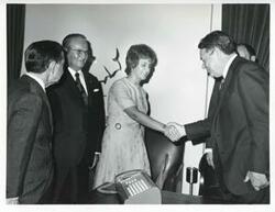 ["Black and white photograph print of President Josip B. Tito of Yugoslavia shaking hands with Hale Boggs. Carl Albert is also shown."]