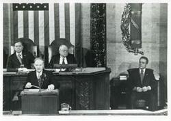 ["Black and white photograph print of Carl Albert and James O. Eastland with others during a joint session of Congress."]
