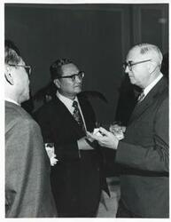 ["Black and white photograph print of three unidentified men talking during the Korean-U.S. Interparliamentary Conference. July 22-23, 1973"]