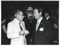 ["Black and white photograph print of unidentified men speaking during the Korean Interparliamentary Conference. July 22-23, 1973"]