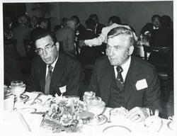 ["Black and white photograph print of Edward Boland and Silvio Conte seated at a dinner table during the Korean-U.S. Interparliamentary Conference. July 22-23, 1973"]