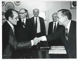 ["Black and white photograph print of Carl Albert in various poses with unidentified people."]
