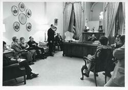 ["Black and white photograph print of Carl Albert in various poses with unidentified people."]