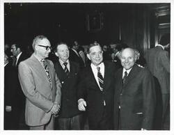 ["Black and white photograph print of Carl Albert in various poses with unidentified people."]