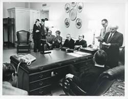 ["Black and white photograph print of Carl Albert in various poses with unidentified people."]