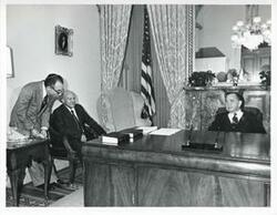 ["Black and white photograph print of Carl Albert in various poses with unidentified people."]