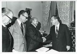 ["Black and white photograph print of Carl Albert in various poses with unidentified people."]