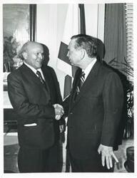 ["Black and white photograph print of Carl Albert in various poses with unidentified people."]