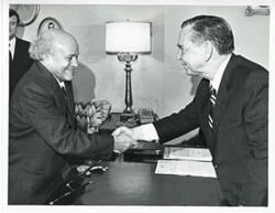 ["Black and white photograph print of Carl Albert in various poses with unidentified people."]