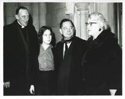 ["Black and white photograph print of Carl Albert and Mary Frances Albert standing with two others."]