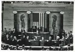 ["Black and white photograph print of Carl Albert and others in Congressional chambers."]