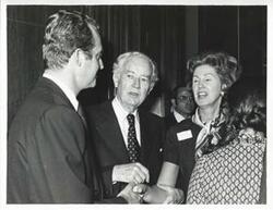 ["Black and white photograph print of Henry Kissinger shaking hands with Mary McLaughlin."]