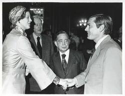 ["Black and white photograph print of Queen Margrethe shaking hands with John Sparkman as Carl Albert and Bill Alexander look on."]