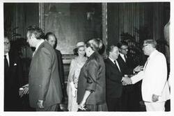 ["Black and white photograph print of Carl Albert, Queen Elizabeth, and Prince Phillip shaking hands with other people during a visit to the U.S."]