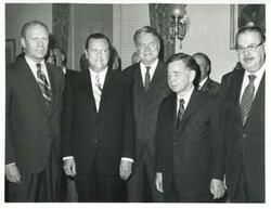 ["Black and white photograph print of Gerald R. Ford, Hale Boggs, Carl Albert, Hugh Scott, and others."]