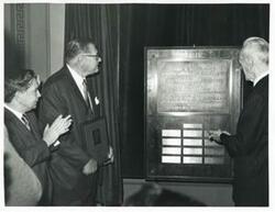["Black and white photograph print of Carl Albert, John McCormack, and others at unidentified function."]