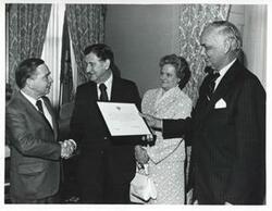 ["Black and white photograph print of Carl Albert in various poses with unidentified people."]