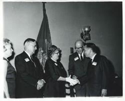 ["Black and white photograph print of Carl Albert in various poses with unidentified people."]