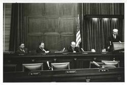 ["Black and white photograph print of Carl Albert, Thomas E. Morgan, Dean Rusk, and John W. McCormack."]