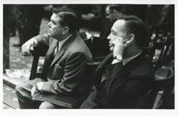 ["Black and white photograph print of Carl Albert seated next to an unidentified man."]