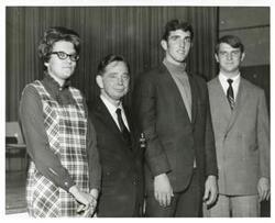["Black and white photograph print of Carl Albert posing with three unidentified people, December 1967"]