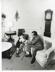 ["Black and white photograph print of Richard M. Nixon with Tracy Greenwood in the Oval Office. February 1969"]