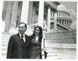 ["Black and white photograph print of Carl Albert walking down the steps of the Capitol with Felda Looper, the first girl page in the House of Representatives"]