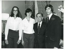 ["Black and white photograph print of Carl Albert posing with three unidentified people."]