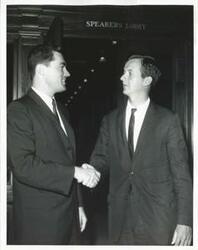 ["Black and white photograph print of Jed Johnson, Jr. posing with an unidentified man."]