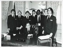 ["Black and white photograph print of Carl Albert posing with Pages. March-April 1975"]