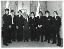 ["Black and white photograph print of Carl Albert with departing Pages. April 30, 1975"]