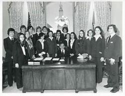 ["Black and white photograph print of Carl Albert standing with the departing Pages (individual names on back of photo) on December 15, 1975"]