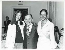 ["Black and white photograph print of Carl Albert posing with Ceci Wolfe and Loise Butler."]