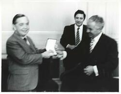 ["Black and white photograph print of Carl Albert with two unidentified men during the House delegation trip. August 1975"]