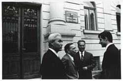 ["Black and white photograph print of Carl Albert speaking with some men outside a building. House delegation trip. August 1975"]