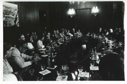 ["Black and white photograph print of Carl Albert and Mary Albert seated at a table with several others during the House delegation trip. August 1975"]