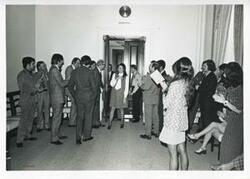 ["Black and white photograph print of several people at Jane England Lawton's farewell party. March 8, 1974"]