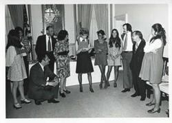 ["Black and white photograph print of Sue Thompson, Kathy Kwock, Jan Lipsen, Helen Newman Tuttle, Loise Butler, Sherry Tonubbee Stewart, Carl Albert, Jane England Lawton, and others at Lawton's party. March 8, 1974"]