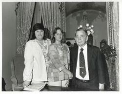 ["Black and white photograph print of Carl Albert posing with Angela Ables and another woman."]