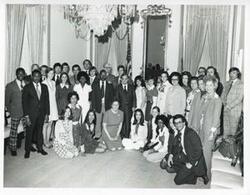 ["Black and white photograph print of Carl Albert posing in a group photo. Names of individuals listed with photo."]