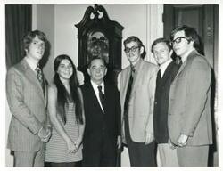 ["Black and white photograph print of Carl Albert with several unidentified people."]