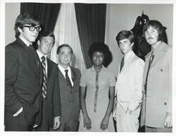 ["Black and white photograph print of Carl Albert posing with Skip Stevens, Basil Bigbie, Shirley Jeter, and two other men."]