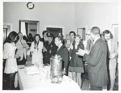 ["Black and white photograph print of Carl Albert with several others getting ready to eat."]
