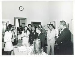 ["Black and white photograph print of Carl Albert with several others getting ready to eat."]