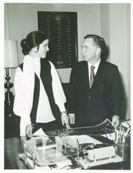 ["Black and white photograph print of Carl Albert speaking to an unidentified woman."]