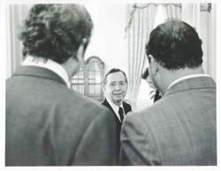 ["Black and white photograph print of Carl Albert speaking with unidentified men."]
