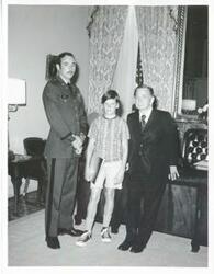 ["Black and white photograph print of Carl Albert posing with an unidentified man and a young boy."]