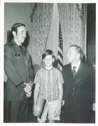 ["Black and white photograph print of Carl Albert posing with an unidentified man and a young boy."]