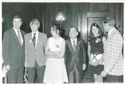 ["Black and white photograph print of Carl Albert standing with Dewey Bartlett and others."]
