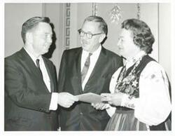 ["Black and white photograph print of Carl Albert in various poses with unidentified people."]